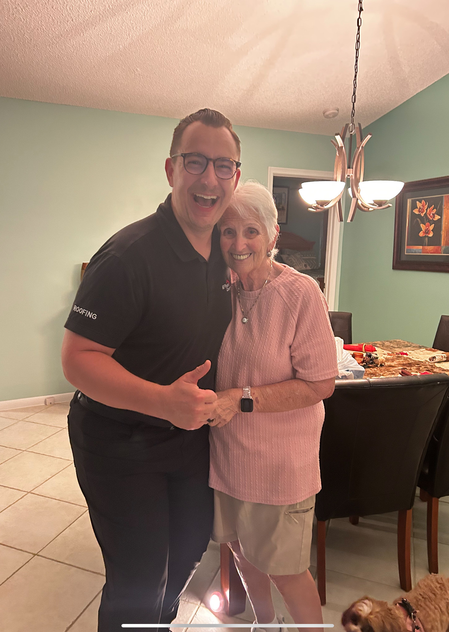 Happy homeowner after roof replacement in Broward County