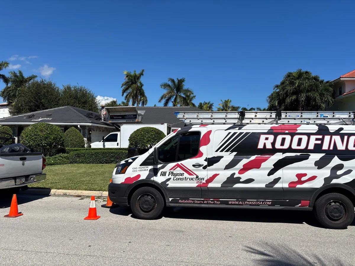 All Phase Construction USA crew and trucks at a flat tile roof repair in Boca Raton, FL