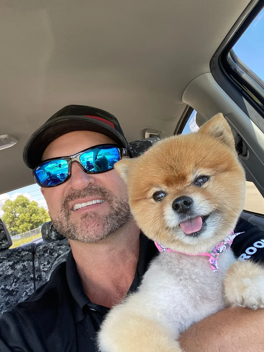 Chris Porosky and Chloe, his 16-year-old dog and All Phase Construction USA Chief Happiness Officer